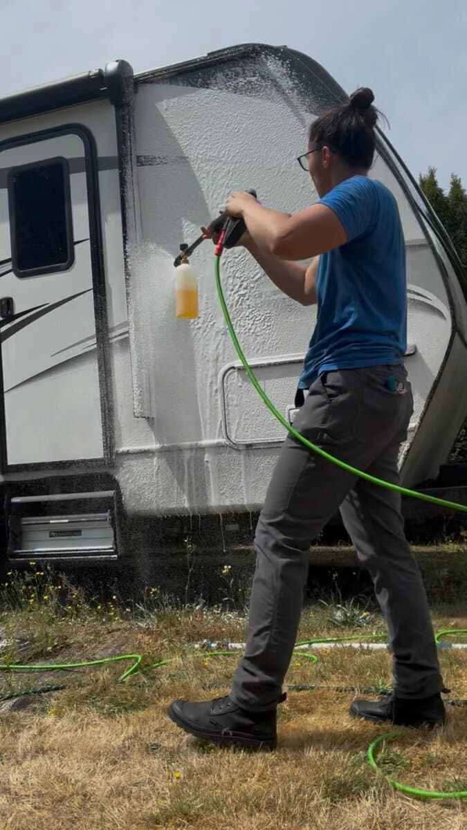 Applying foam soap to a travel trailer exterior