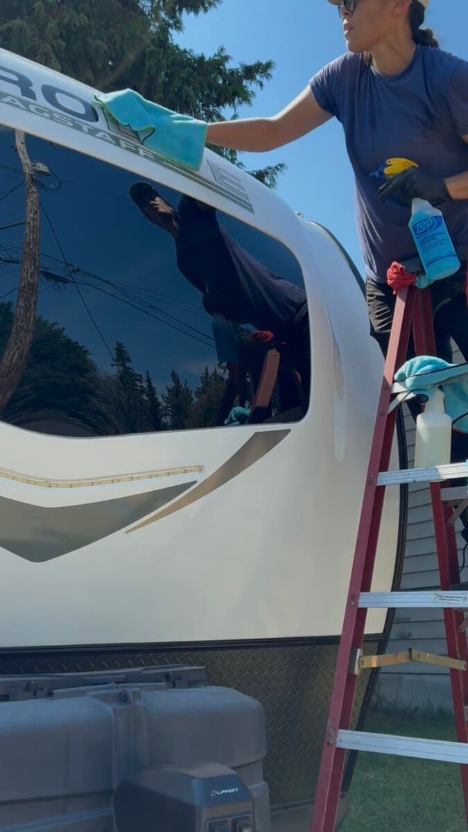 Cleaning windows on a Flagstaff travel trailer